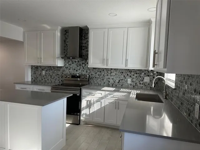 a kitchen with a sink and cabinets