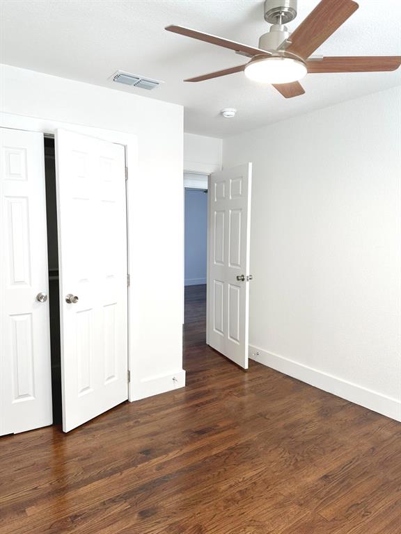 409 Hanbee Street Richardson, TX 75080 - Photo 10 of 18 an empty room with wooden floor and a ceiling fan