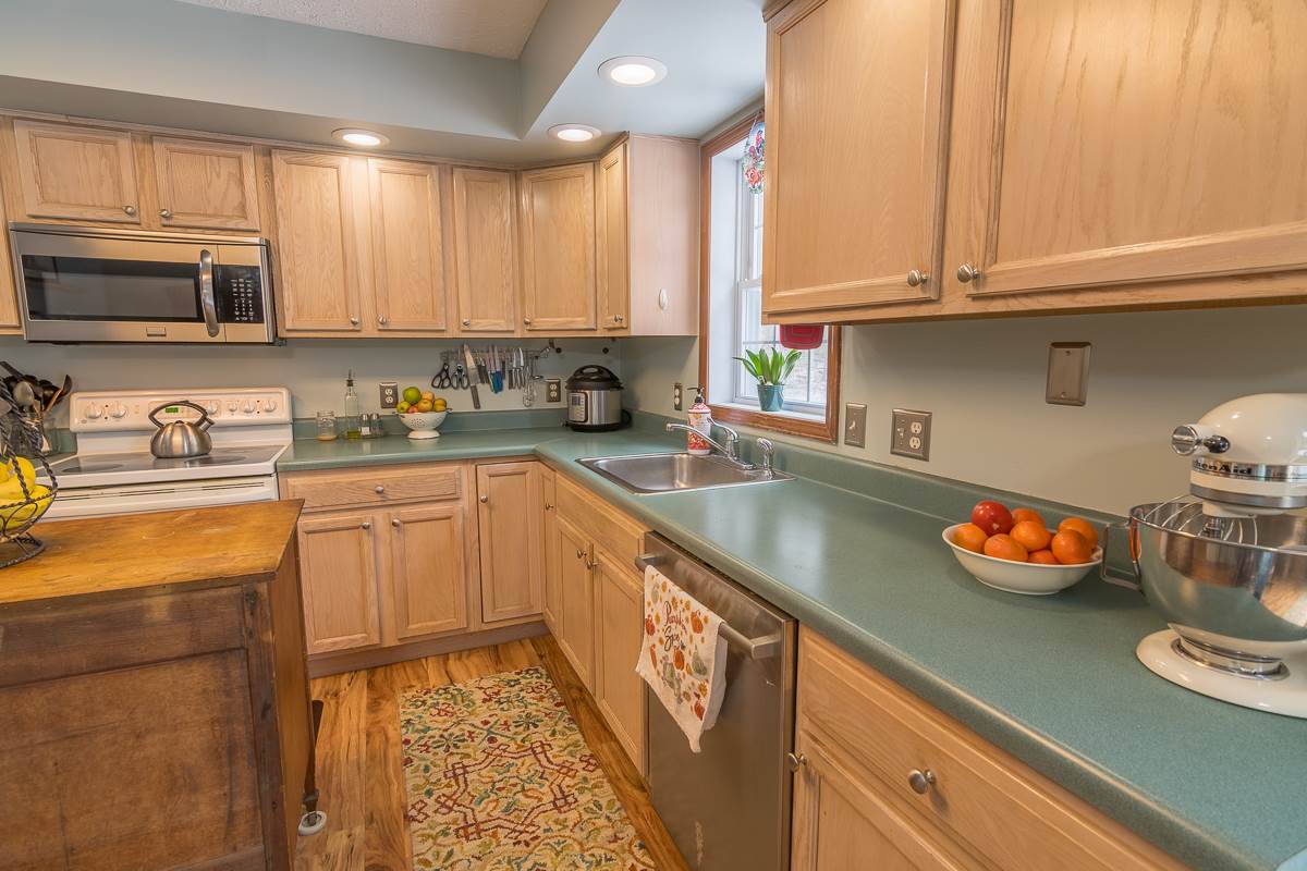 4258 Cold Springs Road Raphine, VA 24472 - Photo 13 of 50 a kitchen with stainless steel appliances granite countertop a sink stove and cabinets