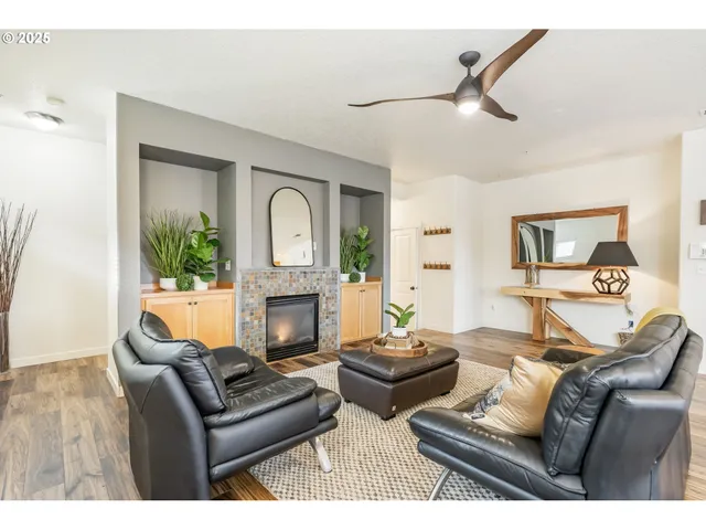 a living room with furniture a fireplace and a flat screen tv