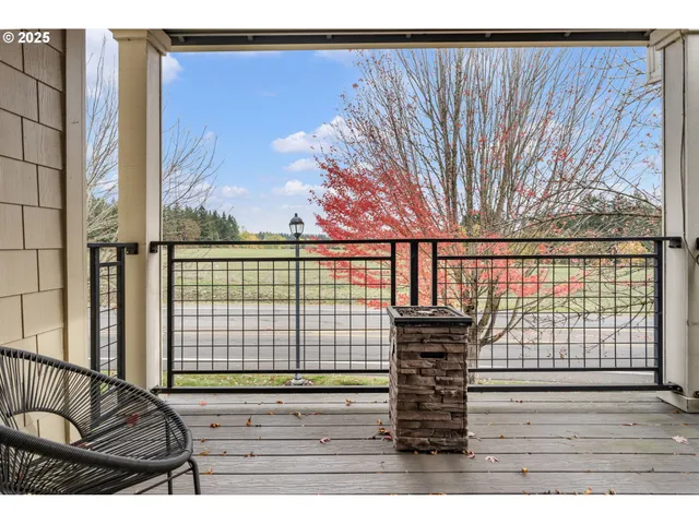 a view of a balcony with floor to ceiling windows and wooden floor