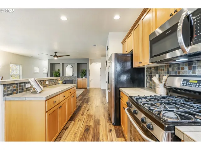 a kitchen with stainless steel appliances granite countertop a stove and a sink