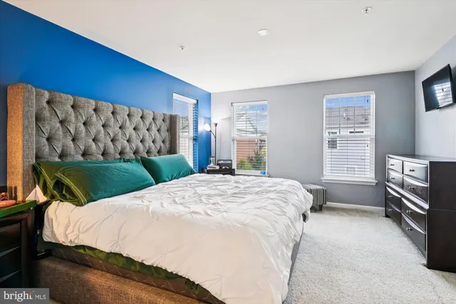 a bedroom with a bed and a television