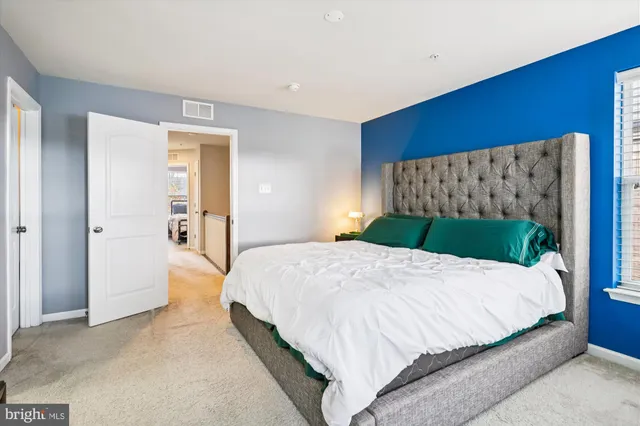 a bedroom with a bed and dresser