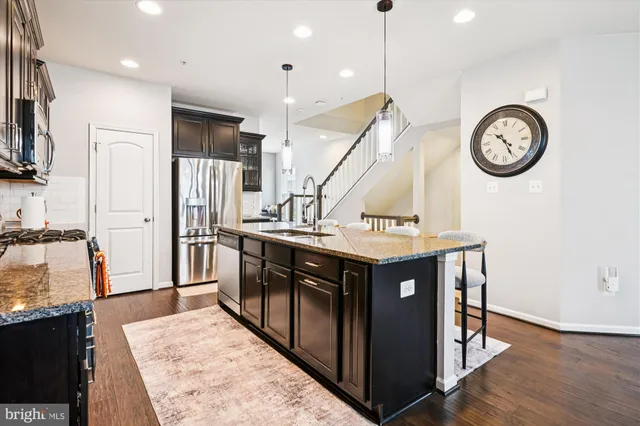 a kitchen with stainless steel appliances granite countertop a stove and a refrigerator