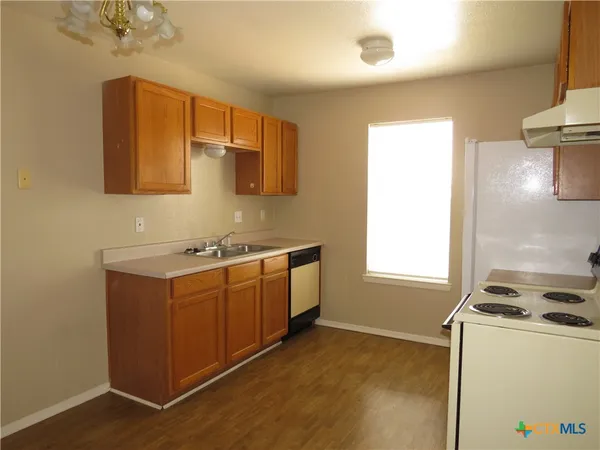 a kitchen with sink cabinets and window