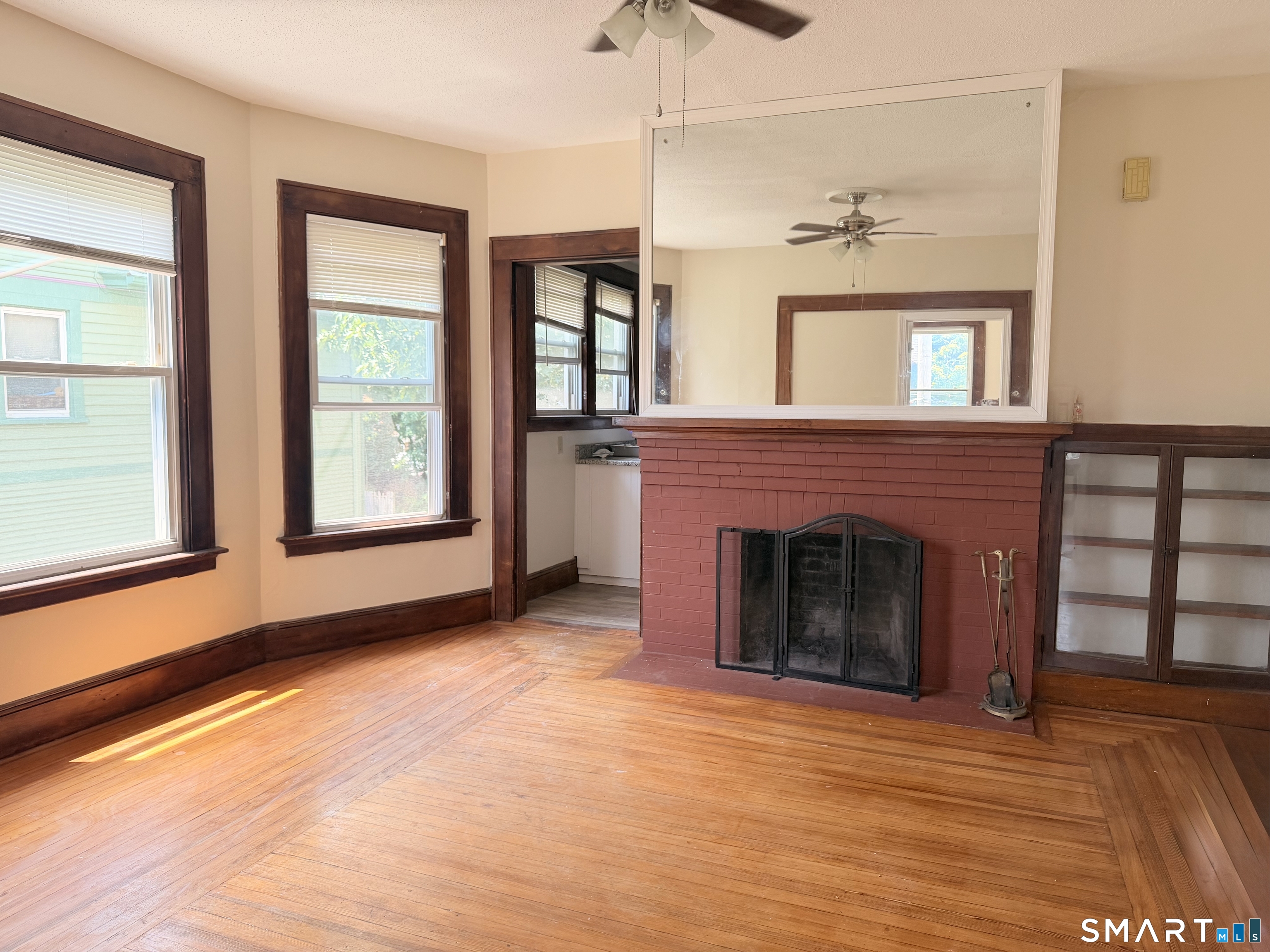 38 Pendleton Street, Unit 2 New Haven, CT 06511 - Photo 3 of 9 an empty room with a fireplace and windows
