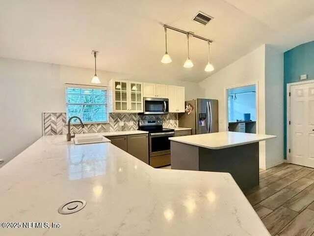 a view of a room with wooden floor