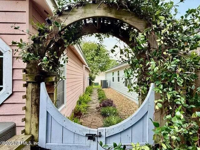 a view of a house with backyard and sitting area