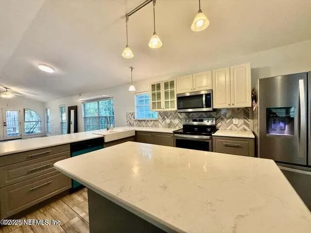 a kitchen with stainless steel appliances and white cabinets
