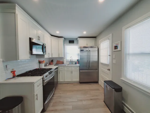 a kitchen with a refrigerator sink and stove