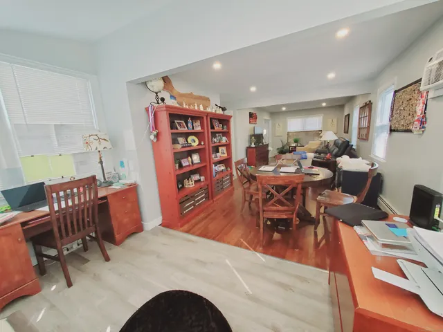 a dining room with furniture and wooden floor