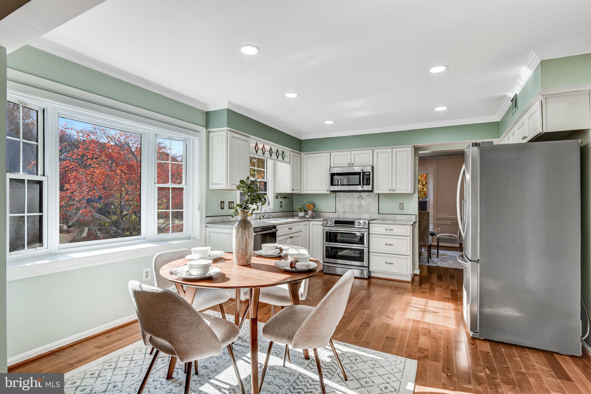 8420 Sweet Pine Court Springfield, VA 22153 - Photo 13 of 45 a dining room with furniture a large window and stainless steel appliances