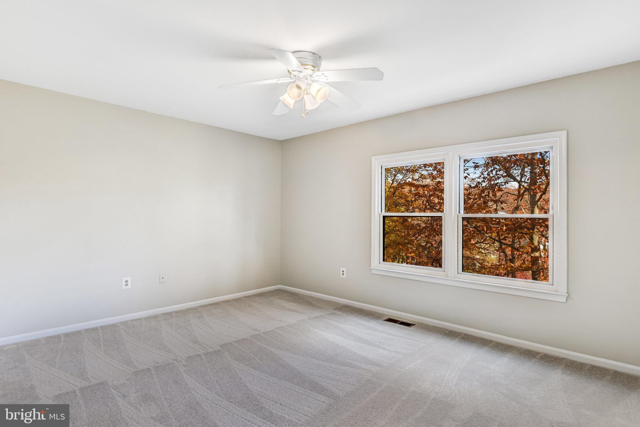 8420 Sweet Pine Court Springfield, VA 22153 - Photo 20 of 45 an empty room with windows and fan