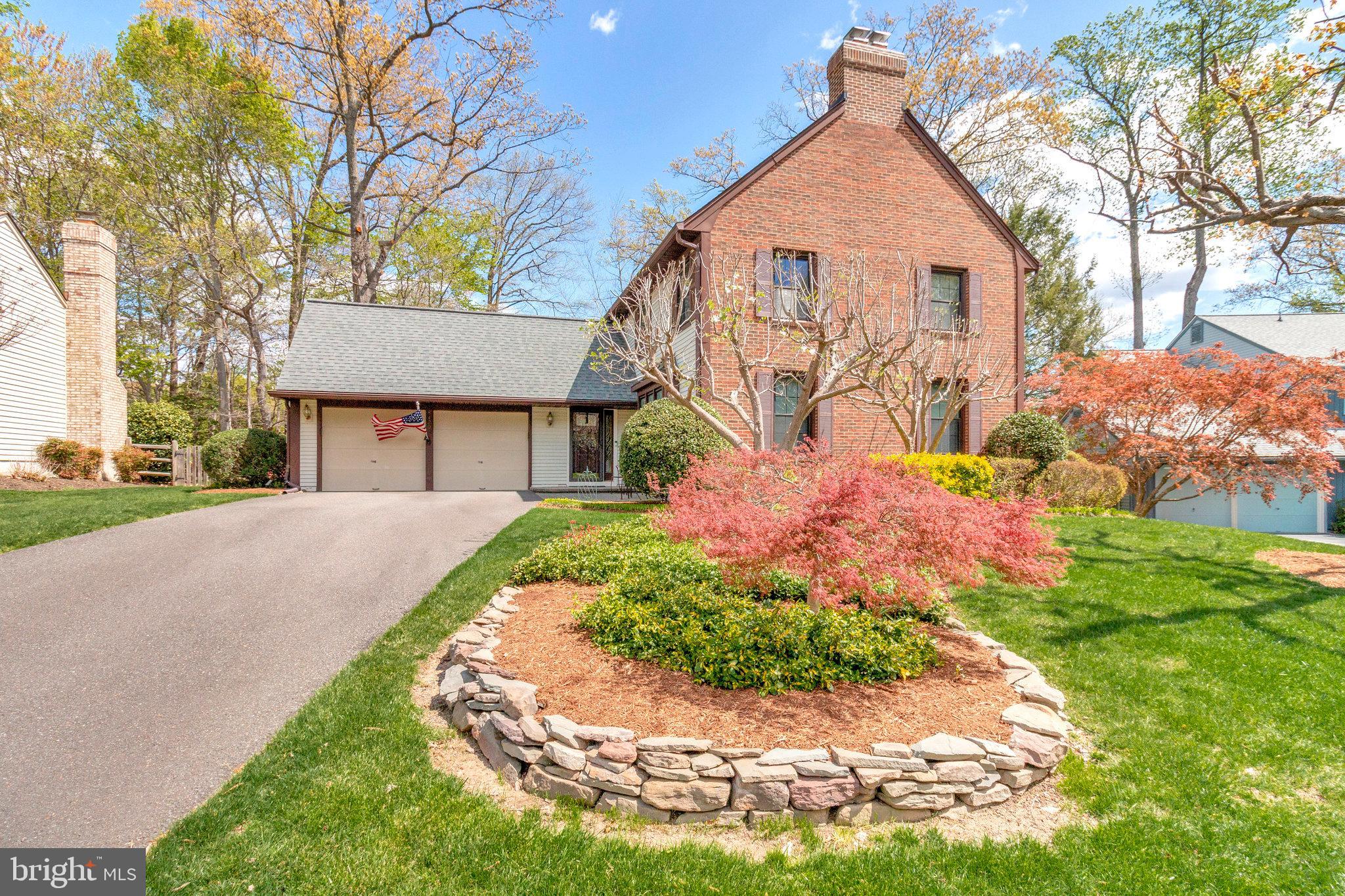 8420 Sweet Pine Court Springfield, VA 22153 - Photo 2 of 45 a front view of a house with a yard and garage