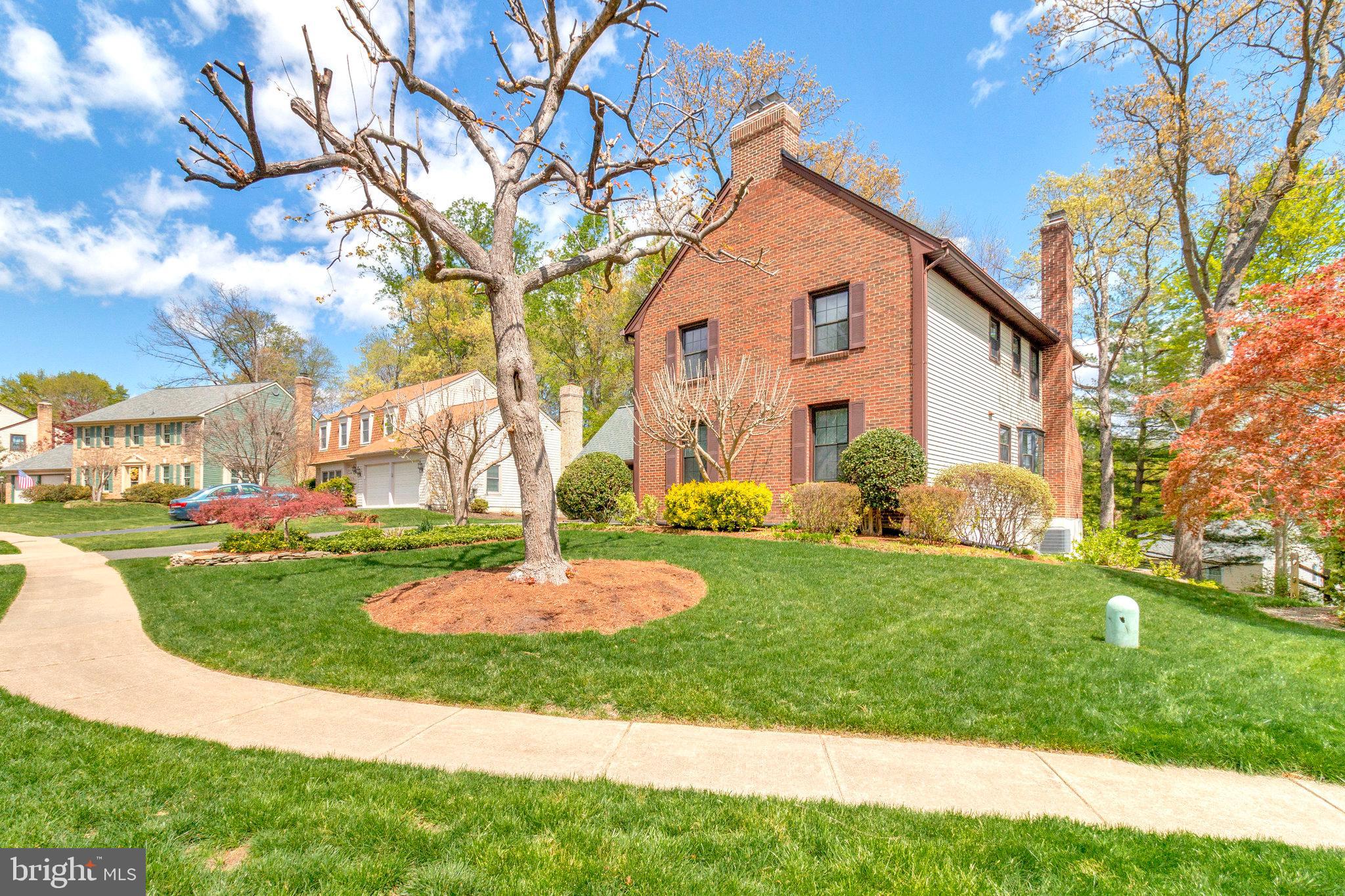 8420 Sweet Pine Court Springfield, VA 22153 - Photo 3 of 45 a front view of a house with a yard and trees