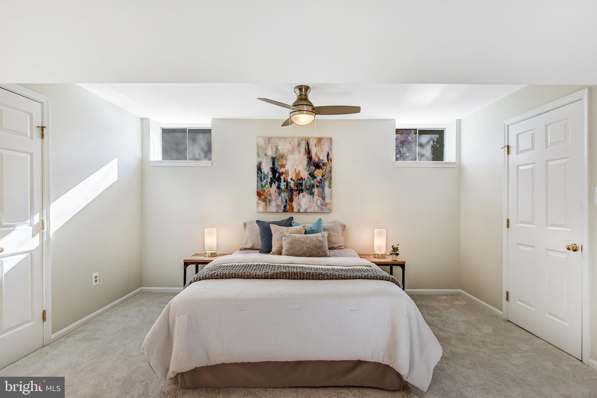 8420 Sweet Pine Court Springfield, VA 22153 - Photo 38 of 45 a bedroom with a bed and a chandelier