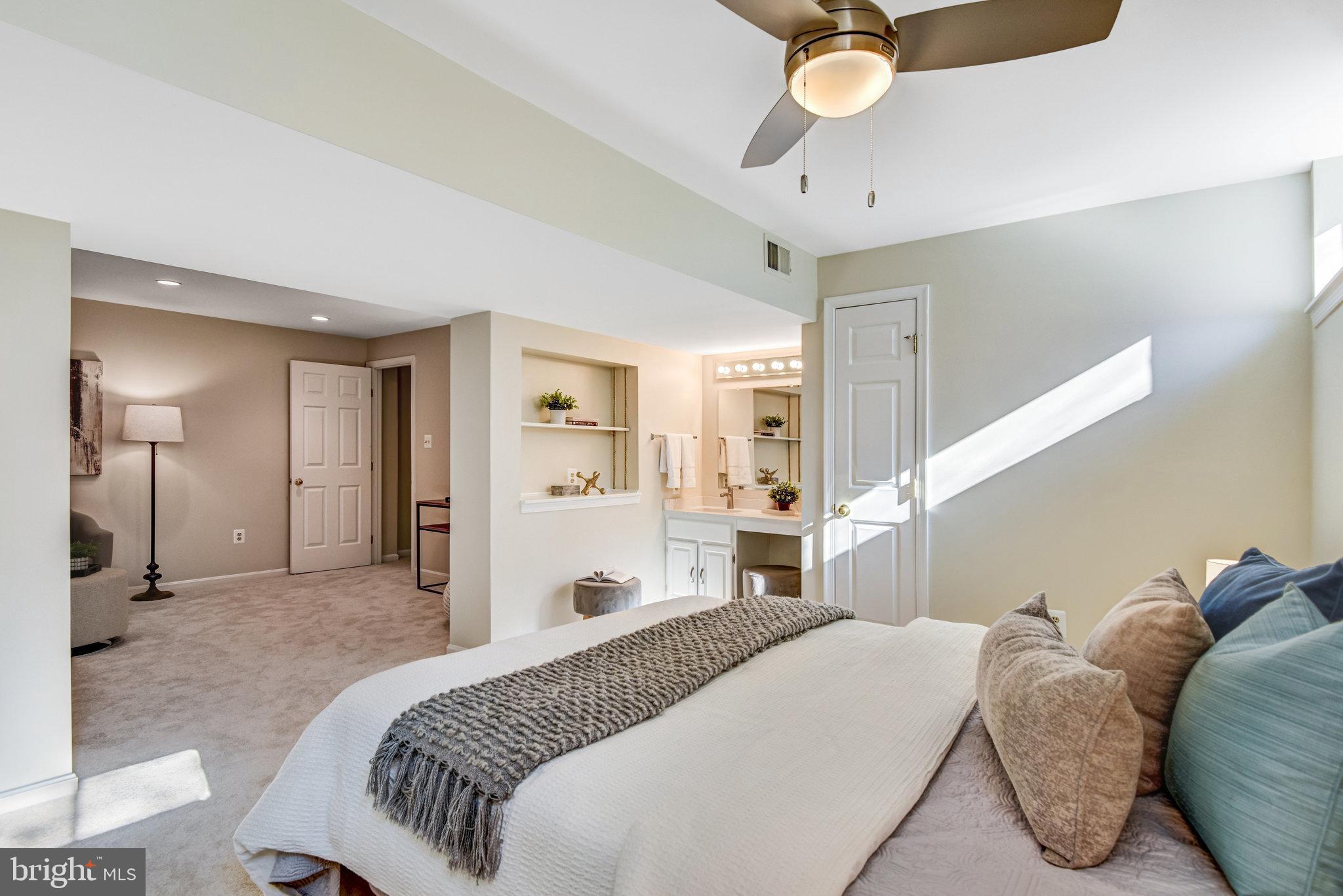 8420 Sweet Pine Court Springfield, VA 22153 - Photo 39 of 45 a spacious bedroom with a bed and ceiling fan