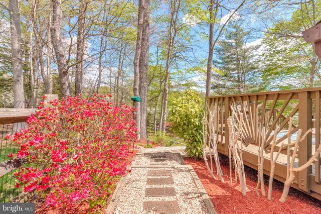 a front view of a house with a lot of flowers