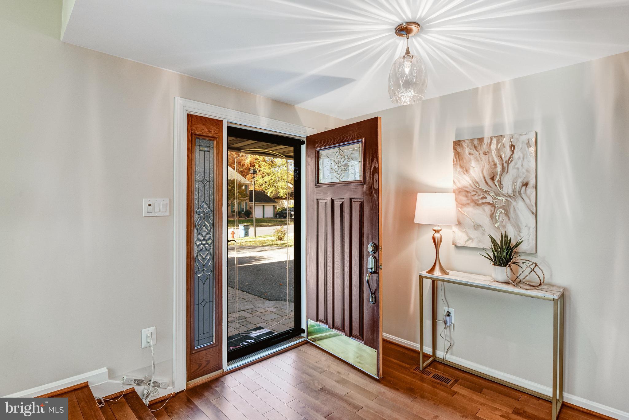 8420 Sweet Pine Court Springfield, VA 22153 - Photo 4 of 45 a view of a hallway with wooden floor and front door