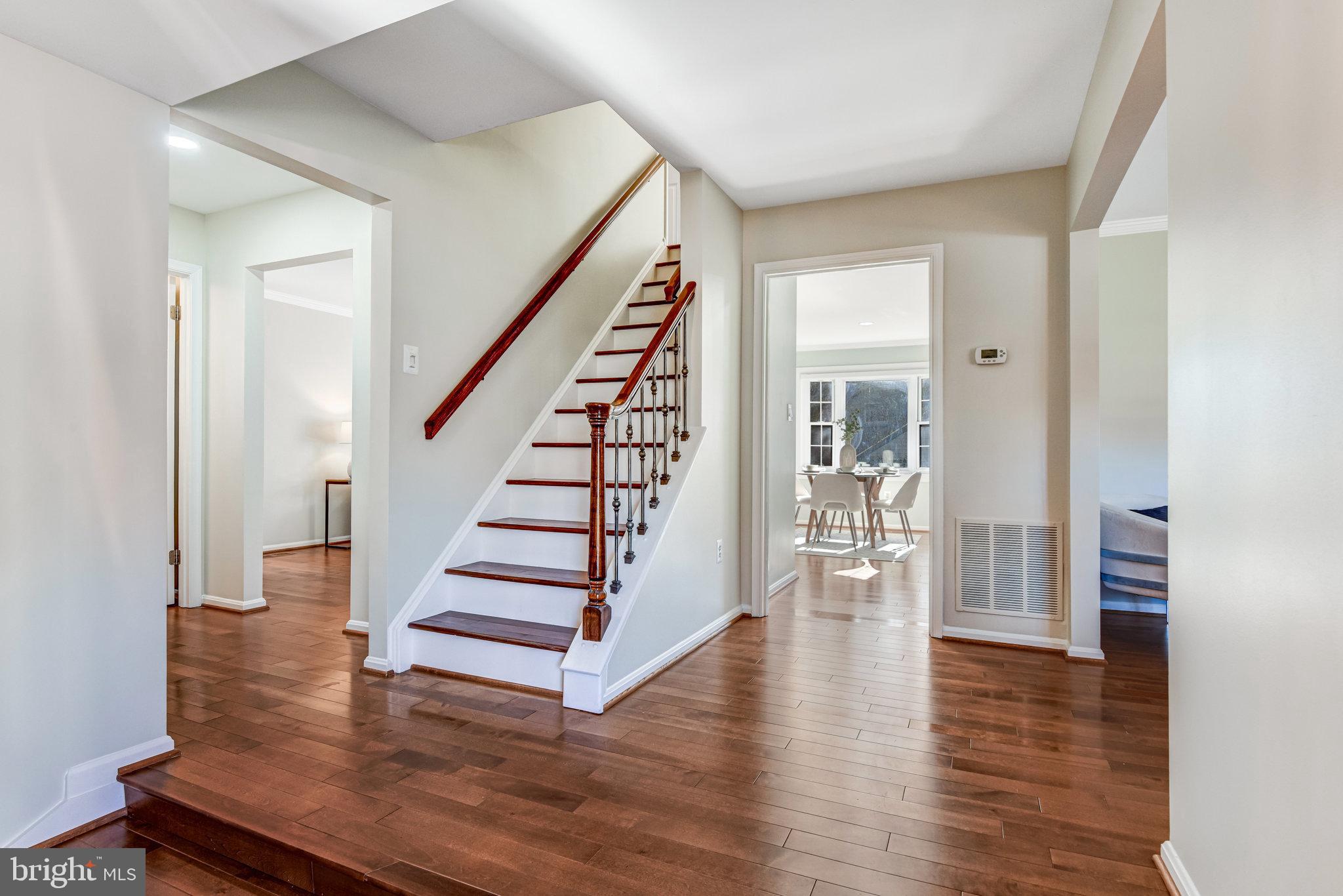 8420 Sweet Pine Court Springfield, VA 22153 - Photo 5 of 45 a view of entryway with wooden floor and stairs