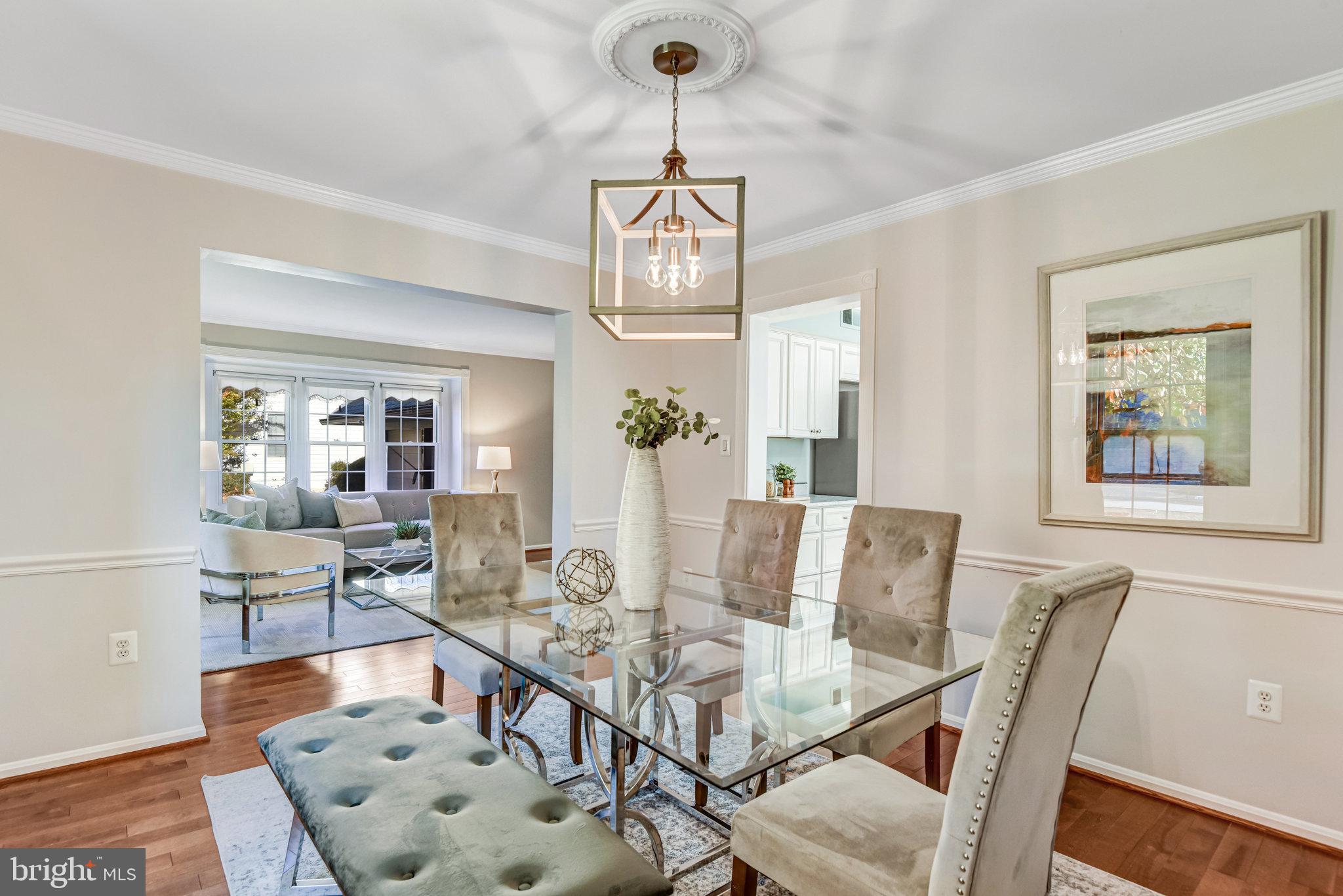 8420 Sweet Pine Court Springfield, VA 22153 - Photo 9 of 45 a view of a dining room with furniture wooden floor and chandelier