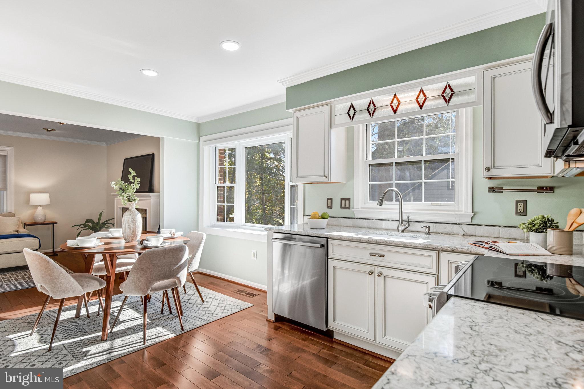 8420 Sweet Pine Court Springfield, VA 22153 - Photo 10 of 45 a dining hall with stainless steel appliances granite countertop a stove a sink dishwasher and white cabinets with wooden floor