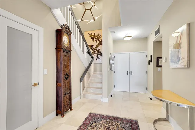 a view of entryway with furniture and wooden floor