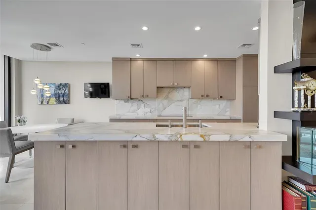 a kitchen with stainless steel appliances granite countertop a sink and a stove