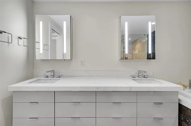 a bathroom with a granite countertop sink a toilet a bathtub and shower
