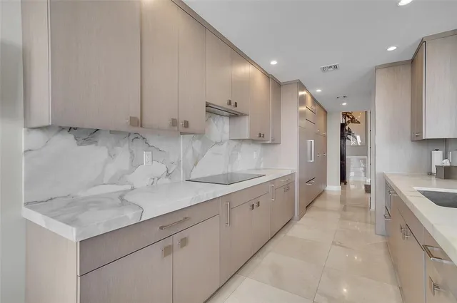 a large kitchen with stainless steel appliances kitchen island granite countertop a sink and cabinets