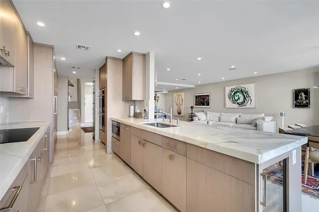 a large kitchen with a lot of counter space and a sink