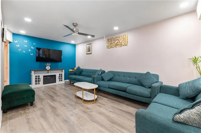 a living room with furniture and a flat screen tv