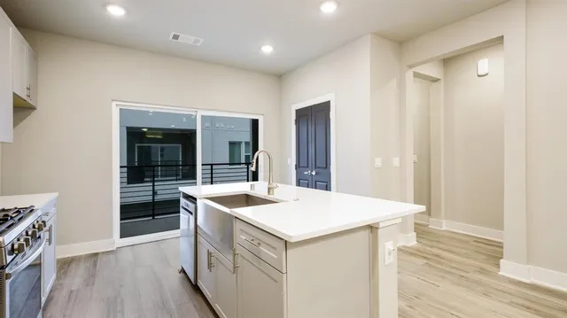 a kitchen that has a sink and a stove in it