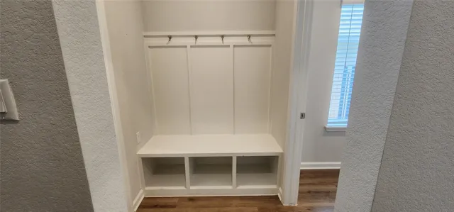 a white toilet sitting next to a sink and vanity