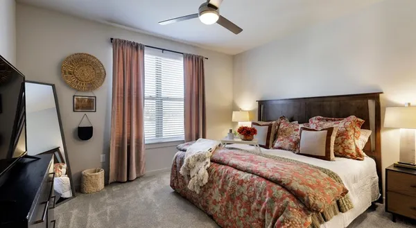 a bedroom with a bed and a window