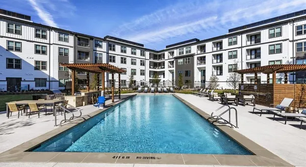 a swimming pool view with a outdoor seating