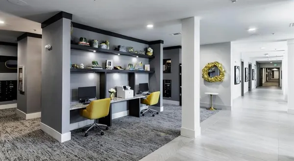 a living room with fireplace furniture and a rug