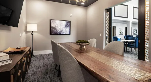 a dining room with furniture and wooden floor