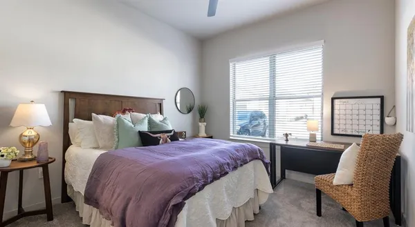 a bedroom with a bed and glass window