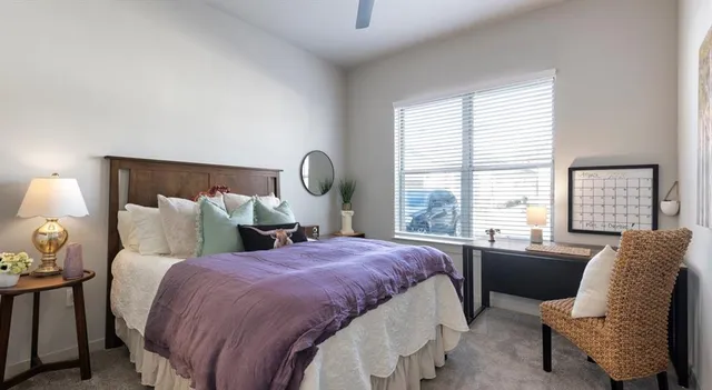 a bedroom with a bed and glass window