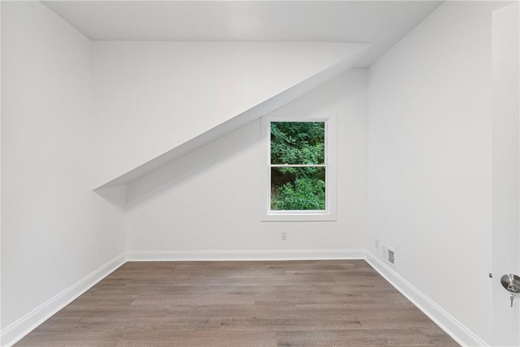 875 Dickson Road Sewickley, PA 15143 - Photo 23 of 29 an empty room with wooden floor and windows