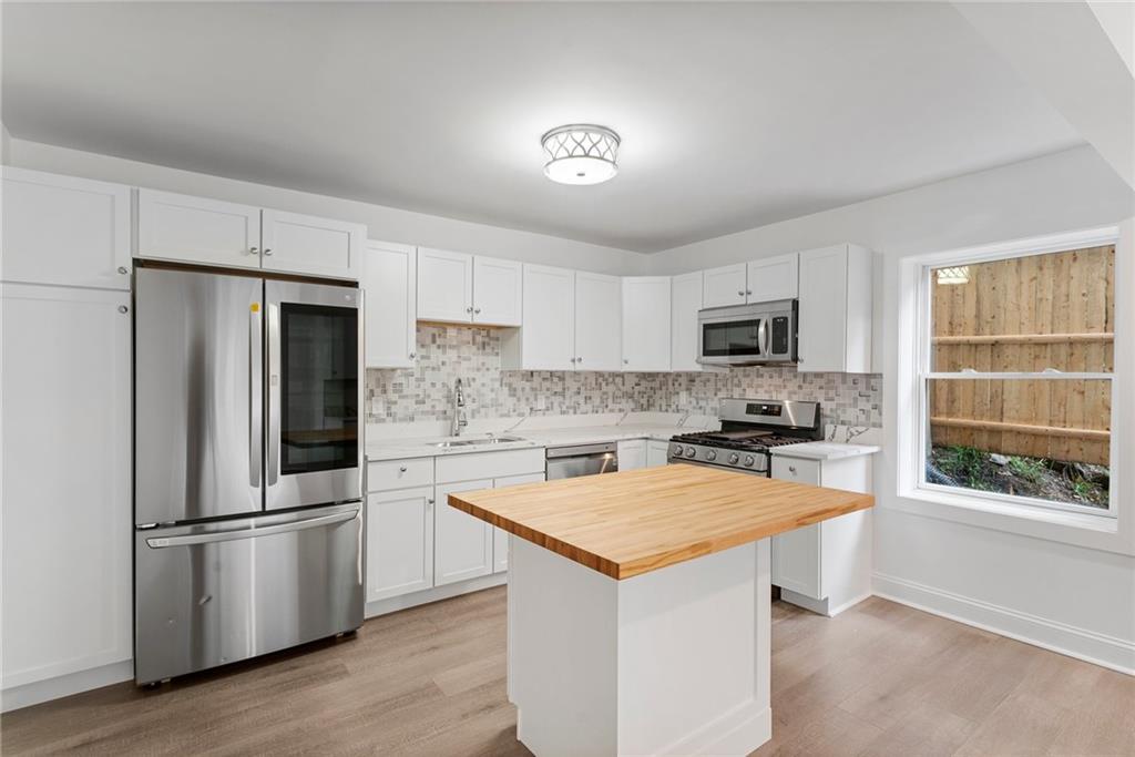 875 Dickson Road Sewickley, PA 15143 - Photo 6 of 29 a kitchen with a refrigerator a microwave a sink and a stove