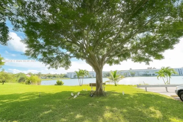 a view of yard with swimming pool and green space