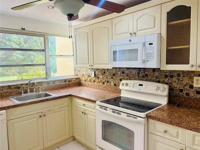 a view of white cabinets and sink