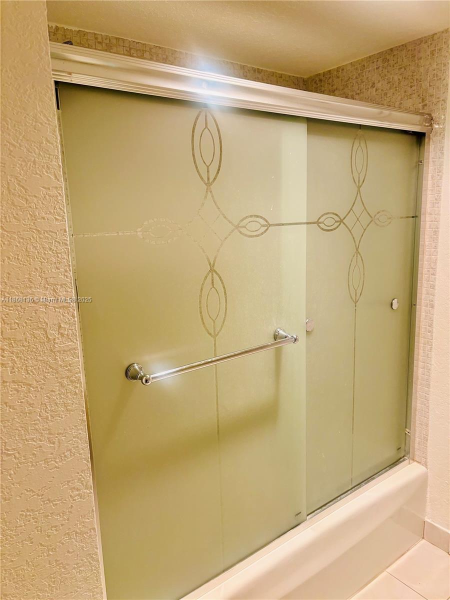 950 Northeast 199th Street, Unit 1A 101 Miami, FL 33179 - Photo 8 of 10 a bathroom with a shower