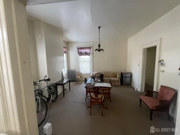 a living room with furniture a window and gym equipment