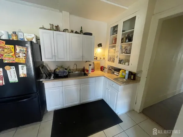 a kitchen with a sink a stove and cabinets