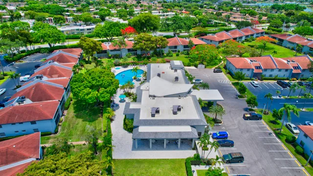 a living room with patio furniture and potted plants