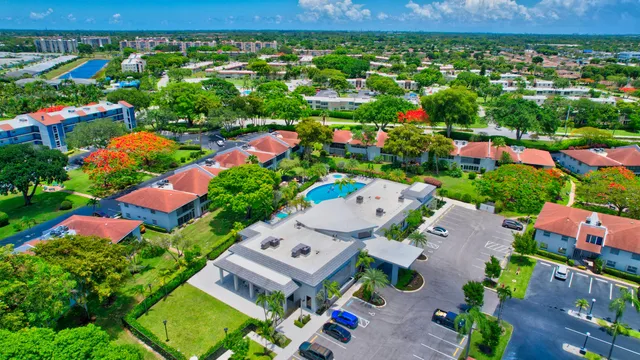 a living room with furniture a large window and stainless steel appliances
